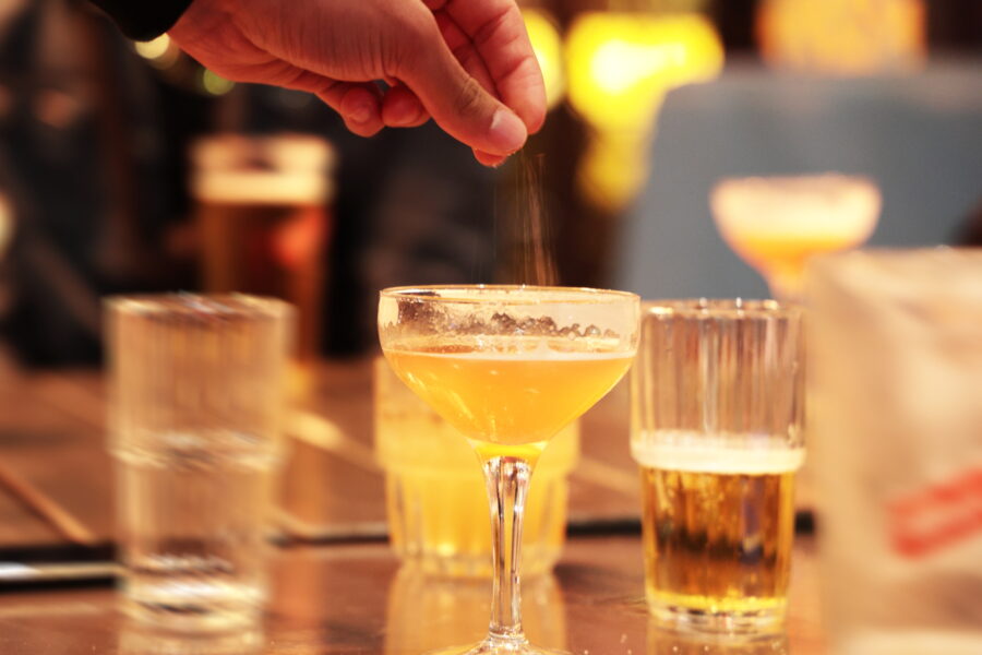 Credit: Peter Cade_GettyImages. Spiking drink with drugs in a bar or night club